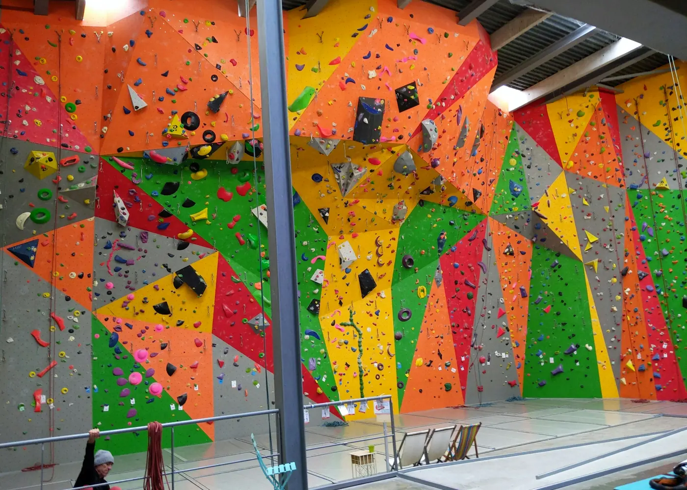 A colourful indoor climbing wall with angular panels